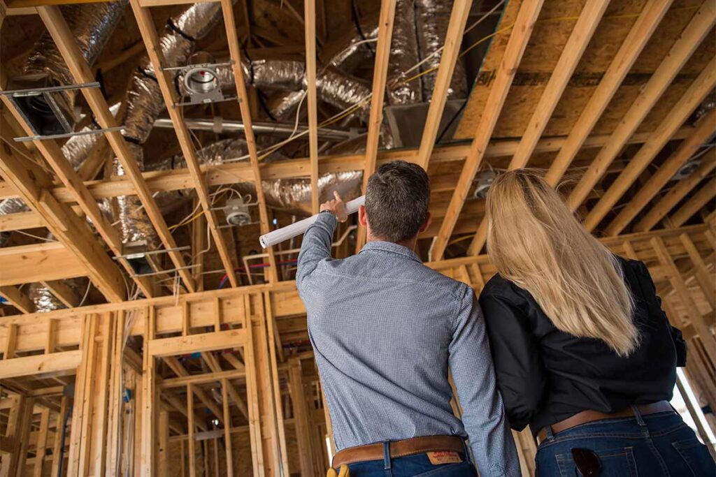 homeowner and tech discussing a new construction